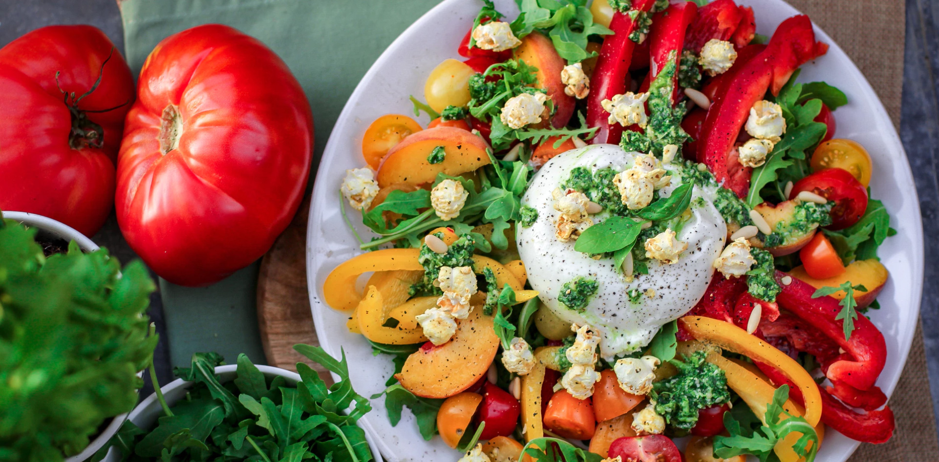 Salad on a plate and vegetables nearby