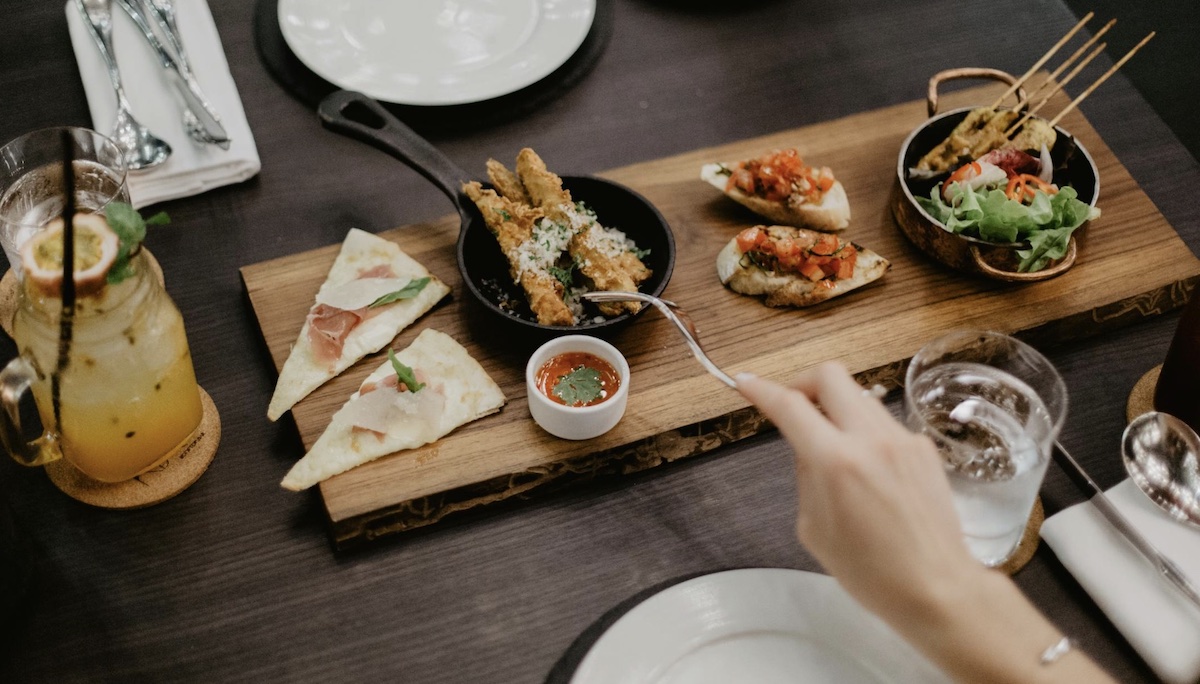 Enjoying food. Image: Pexels - ROMAN ODINTSOV