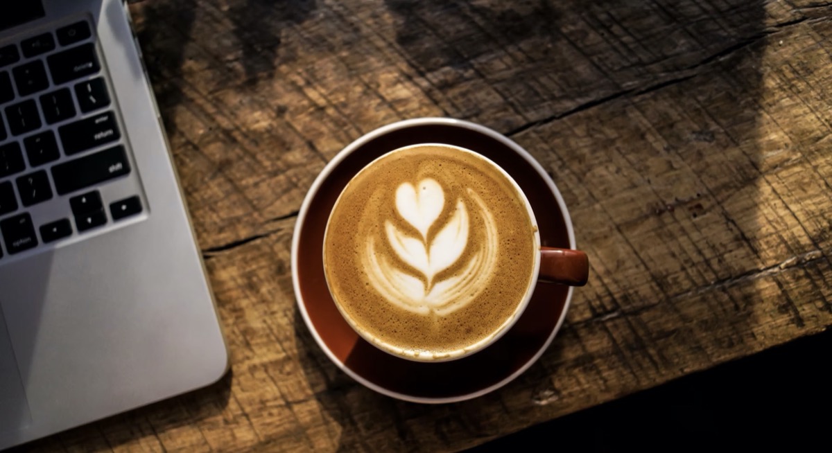 Coffee next to a laptop