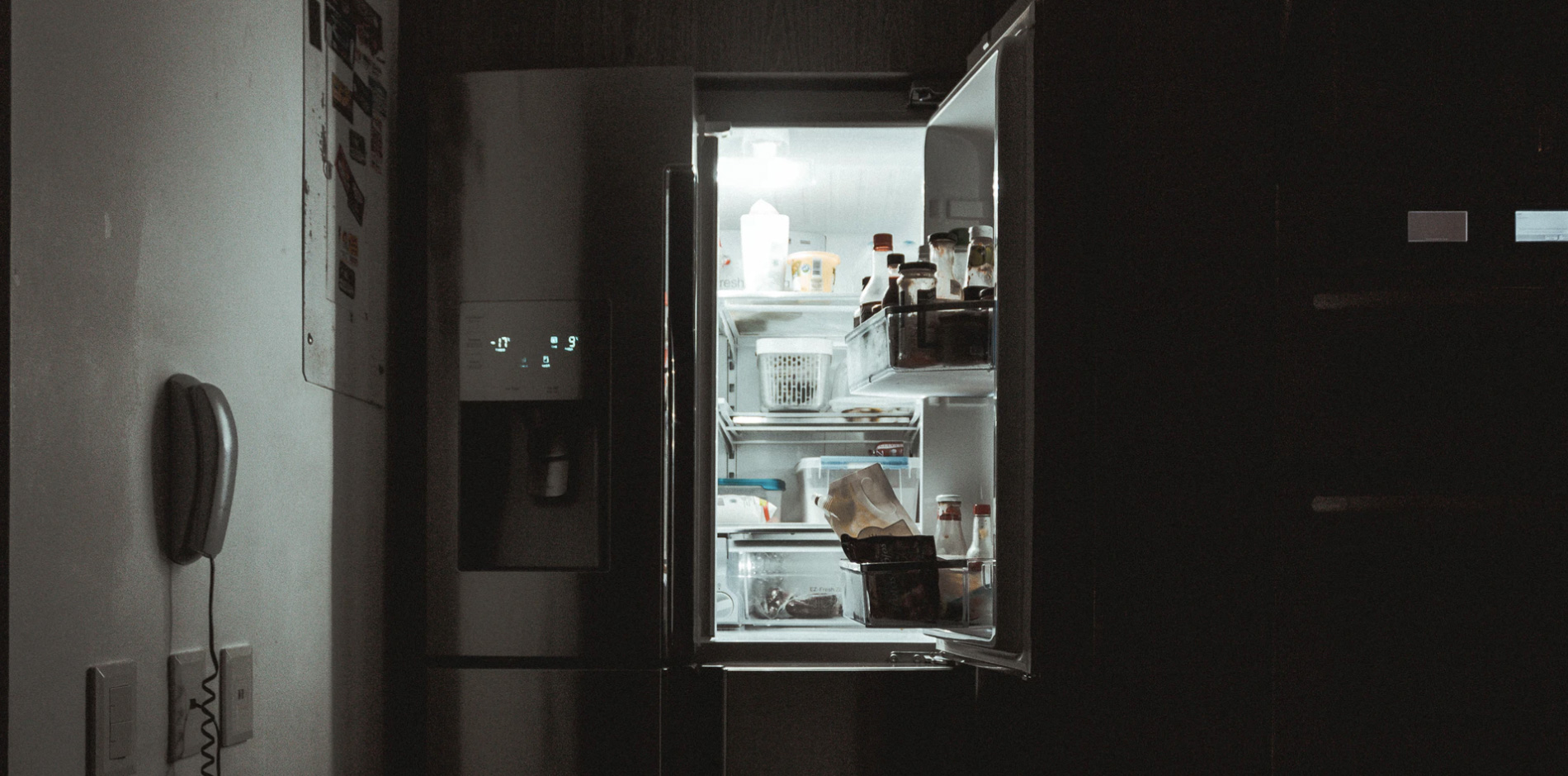 An open fridge door with food inside 