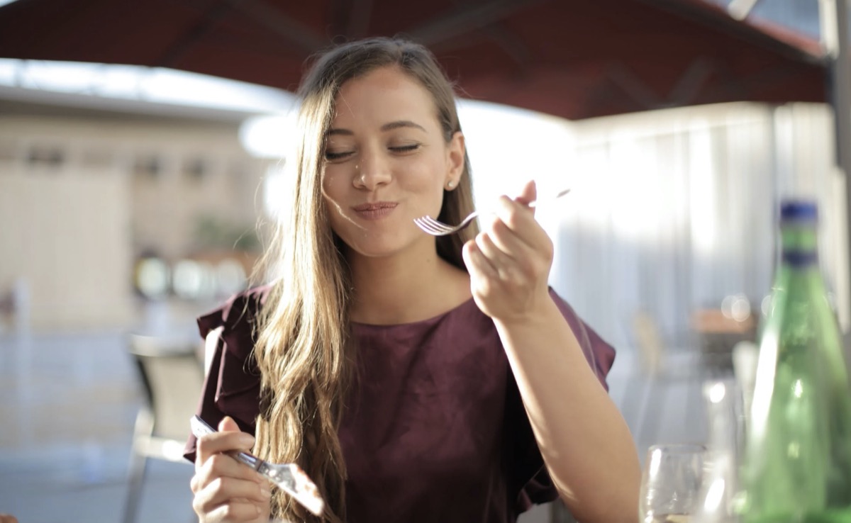 Woman enjoying the food she is eating.