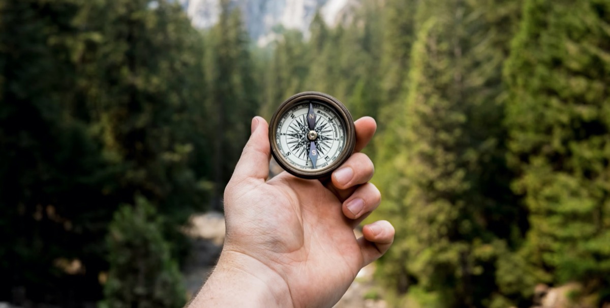 Person holding compass. Unsplash - Jamie Street