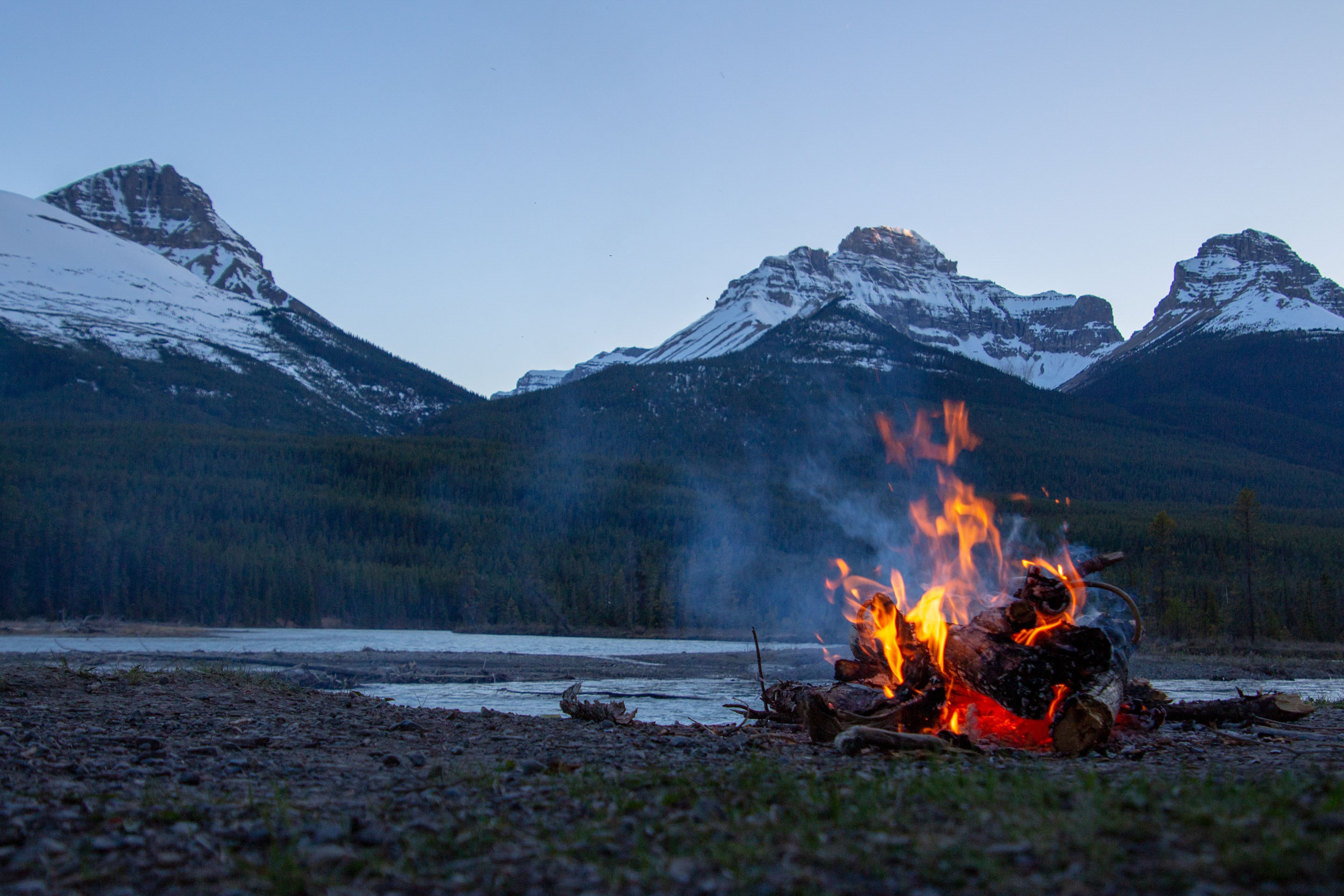 Summer time fire-it in front of mountains. Unsplash - Courtnie Tosana