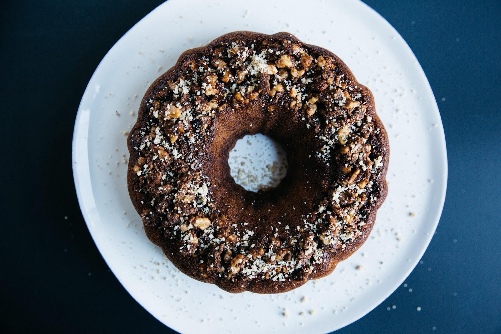 A chocolate bundt cake on a white plate