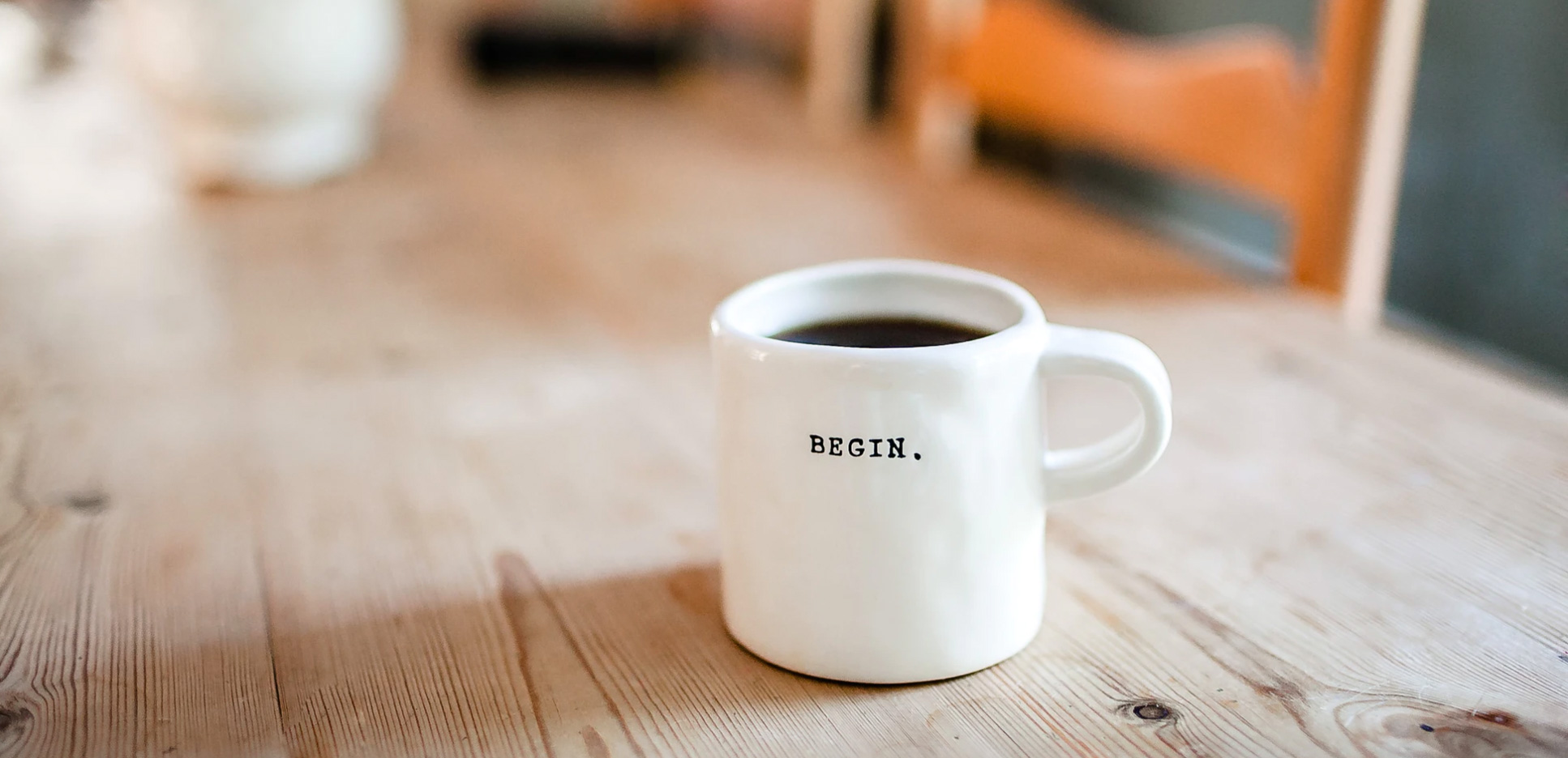 A coffee mug that says begin on it 