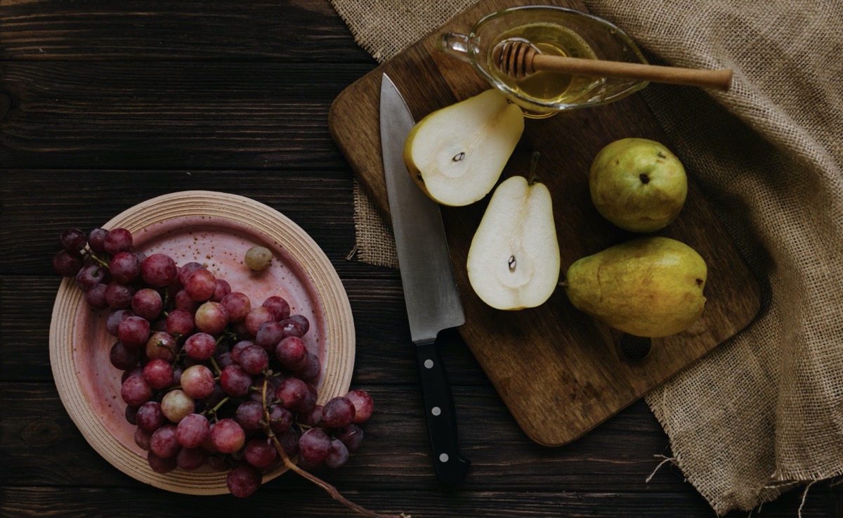 Pears and grapes on a cutting board