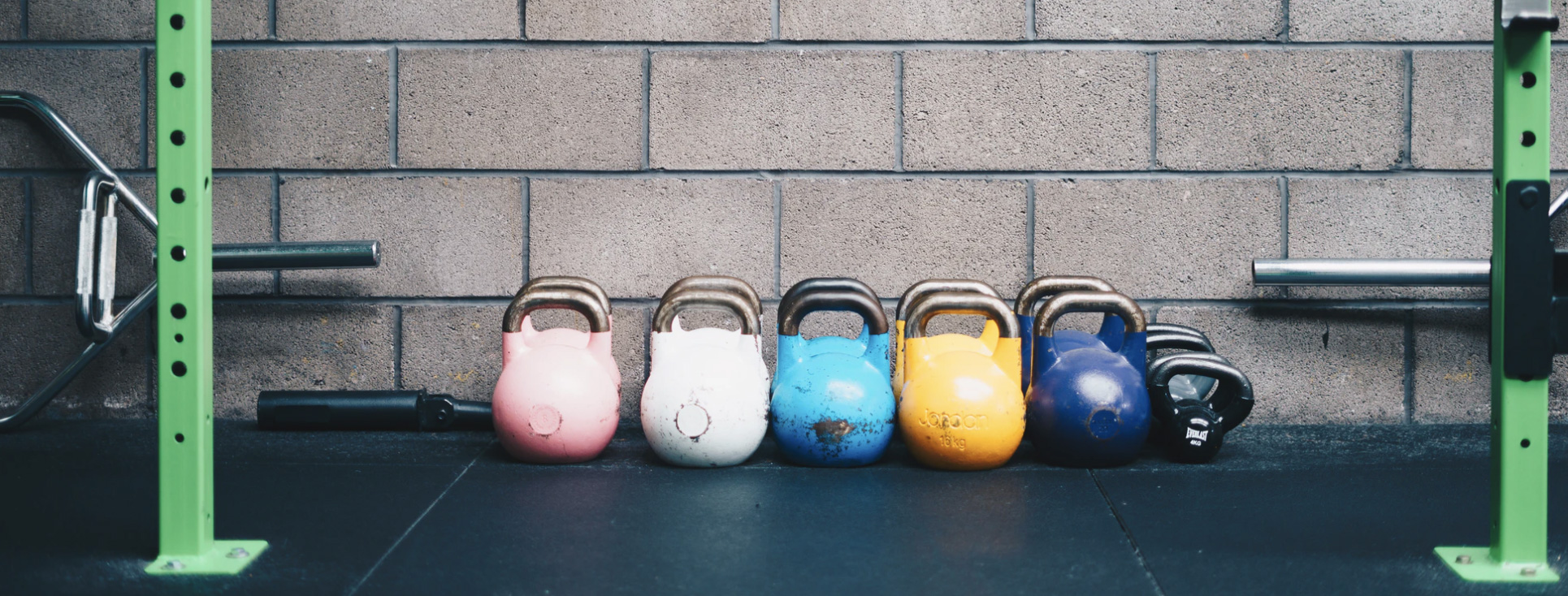 Kettlebells lined up in a gym for workout