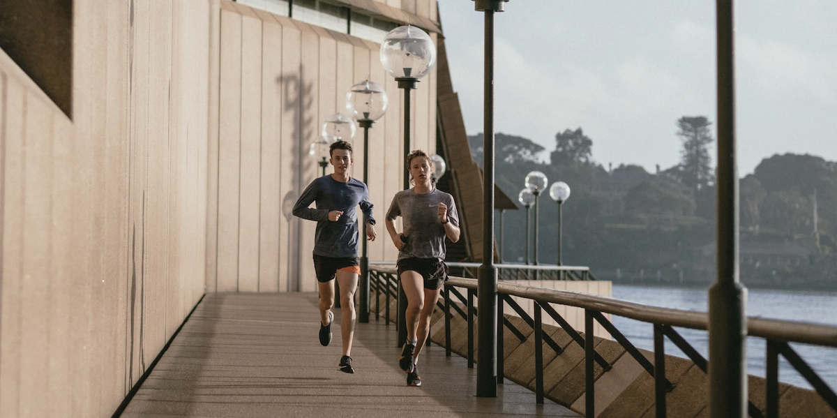 Woman and man running outside living active lifestyle