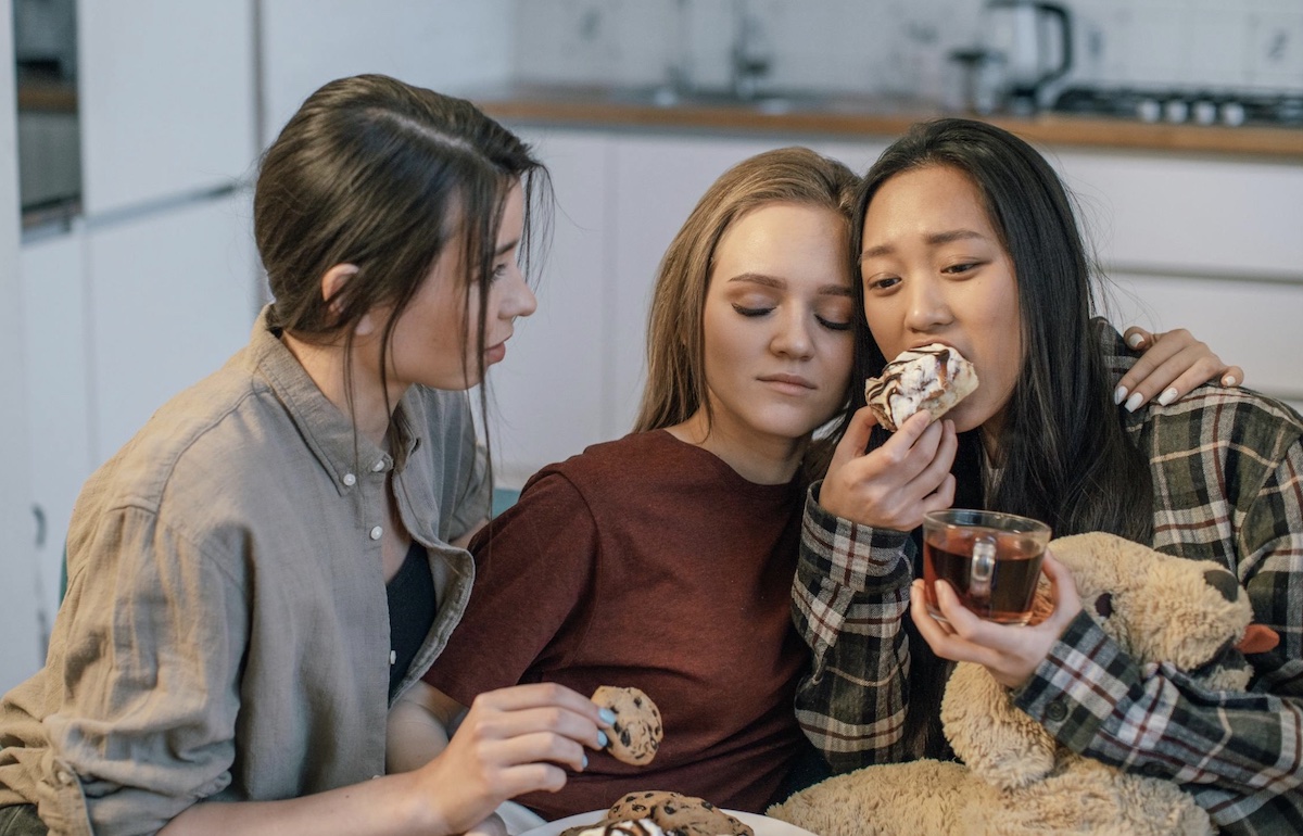 Friends eating together during stressful time. Image: Pexels - Alena Darmel