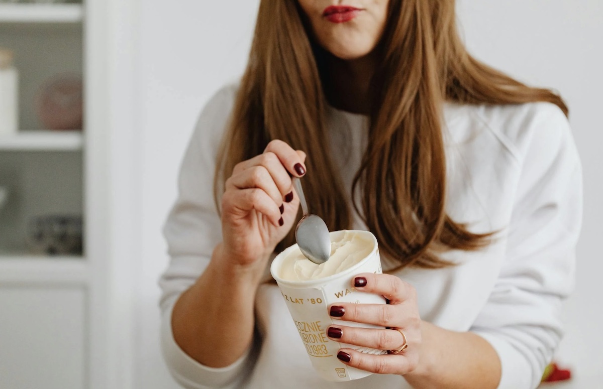 Stress eating a pint of ice cream. Image: Pexels - Karolina Kaboompics